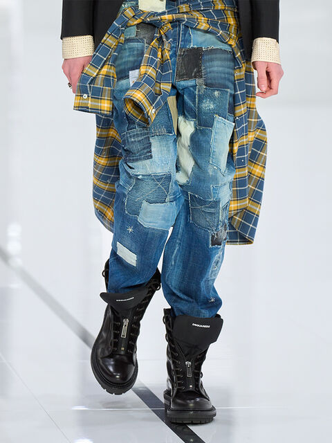 Woman wearing blue washed jeans and black belt with DSQ2 plaque